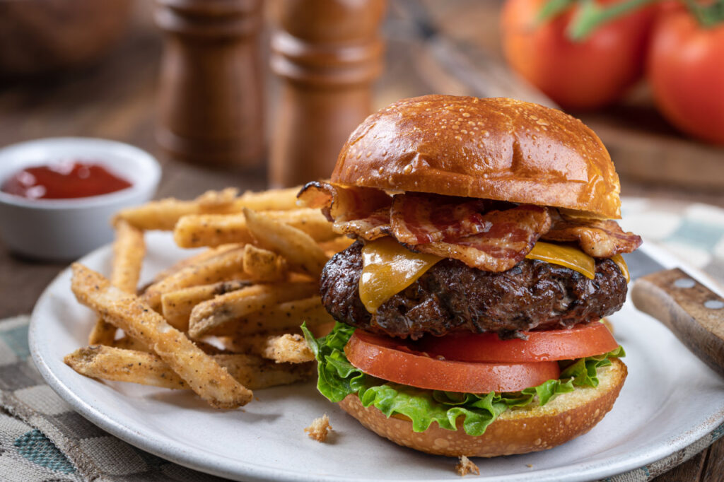 A plate with a cheeseburger and fries